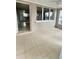 Bright sunroom featuring tile flooring, large windows, and access to the kitchen at 72 Lake Shore Dr, Palm Harbor, FL 34684
