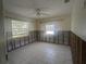 Bedroom with tiled floor, ceiling fan, and natural light from two windows at 7832 3Rd S Ave, St Petersburg, FL 33707