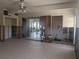 Spacious living room with tile floors undergoing renovations with exposed framing at 7832 3Rd S Ave, St Petersburg, FL 33707