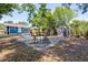 Inviting backyard featuring a patio, outdoor seating, shed, and ample green space at 910 E Chelsea St, Tampa, FL 33603