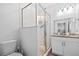 Well-lit bathroom featuring modern shower with glass door, granite countertop, and stylish fixtures at 910 E Chelsea St, Tampa, FL 33603