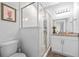 Bright bathroom featuring a modern shower with glass doors, vanity with granite countertop, and stylish fixtures at 910 E Chelsea St, Tampa, FL 33603