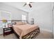 Well-lit bedroom with carpet, neutral color, ceiling fan, and view of the living room at 910 E Chelsea St, Tampa, FL 33603