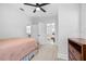 View of the bedroom with doorways leading to the bathroom, living room, and dining area at 910 E Chelsea St, Tampa, FL 33603