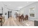 Bright dining room features light hardwood floors, a dining table, and white walls at 910 E Chelsea St, Tampa, FL 33603