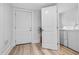 Entryway leading to laundry room with washer and dryer featuring wood-look flooring and white doors at 910 E Chelsea St, Tampa, FL 33603