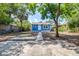 Charming blue single-story home with a well-maintained lawn and inviting walkway at 910 E Chelsea St, Tampa, FL 33603