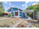 Charming blue craftsman-style home with a red door, white trim, front porch, and carport at 910 E Chelsea St, Tampa, FL 33603