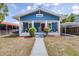 Charming blue craftsman-style home with a red door, white trim, and front porch at 910 E Chelsea St, Tampa, FL 33603