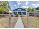 Charming blue craftsman-style home with a red door, white trim, and front porch at 910 E Chelsea St, Tampa, FL 33603