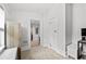 Neutral hallway with a glimpse into another room, showing storage and flooring details at 910 E Chelsea St, Tampa, FL 33603