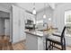 An updated kitchen with a peninsula, breakfast bar, stainless appliances, granite countertops, and white cabinets at 910 E Chelsea St, Tampa, FL 33603