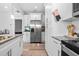 View of the kitchen with stainless steel refrigerator and granite countertops at 910 E Chelsea St, Tampa, FL 33603