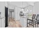 Updated kitchen with breakfast bar, granite countertops, stainless steel appliances, and white cabinets at 910 E Chelsea St, Tampa, FL 33603