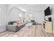 Bright living room features light hardwood floors, a large couch, and a modern design at 910 E Chelsea St, Tampa, FL 33603