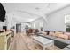 Bright living room features light hardwood floors, a large couch, and a modern design at 910 E Chelsea St, Tampa, FL 33603