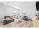 Bright living room features light hardwood floors, a large couch, and a modern design at 910 E Chelsea St, Tampa, FL 33603
