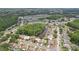 Wide aerial view of the neighborhood shows the proximity to a large pond and lush landscaping at 9322 Via Segovia, New Port Richey, FL 34655