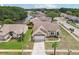 Aerial view of a home in a scenic neighborhood near a pond surrounded by lush landscaping at 9322 Via Segovia, New Port Richey, FL 34655