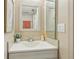 A white sink with mirror, flower, and hand soap in the bathroom at 9322 Via Segovia, New Port Richey, FL 34655