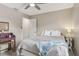 Bright bedroom featuring a ceiling fan, window, and a rustic desk with mirror at 9322 Via Segovia, New Port Richey, FL 34655