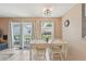 Bright dining area features sliding glass doors to the outside, and a modern light fixture at 9322 Via Segovia, New Port Richey, FL 34655
