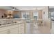Open concept kitchen and dining area featuring bright lighting and backyard views at 9322 Via Segovia, New Port Richey, FL 34655
