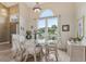 Elegant dining area with high ceilings, arched window and natural light at 9322 Via Segovia, New Port Richey, FL 34655