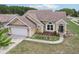 Single-story home with a manicured lawn, flower beds and an attached two-car garage, beautifully designed with modern fixtures at 9322 Via Segovia, New Port Richey, FL 34655