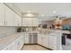 The kitchen features stainless steel appliances, white cabinetry and plenty of counter space at 9322 Via Segovia, New Port Richey, FL 34655