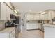 Spacious kitchen featuring stainless steel appliances, ample cabinet space, and tile flooring at 9322 Via Segovia, New Port Richey, FL 34655