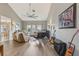 Bright and airy living room with hardwood flooring, a ceiling fan, comfortable seating, and natural light at 9322 Via Segovia, New Port Richey, FL 34655