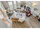 Open-concept living room with hardwood flooring, a ceiling fan, natural light, and comfortable seating at 9322 Via Segovia, New Port Richey, FL 34655