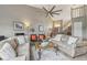 Cozy living room featuring comfortable seating, a ceiling fan, neutral decor, and a view of the foyer at 9322 Via Segovia, New Port Richey, FL 34655
