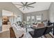 Inviting living room featuring hardwood floors, neutral decor, large windows, and comfortable seating at 9322 Via Segovia, New Port Richey, FL 34655