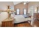 Spacious main bedroom featuring hardwood floors, a ceiling fan, and two windows letting in natural light at 9322 Via Segovia, New Port Richey, FL 34655