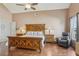 A spacious main bedroom with a ceiling fan, high ceilings, and a luxurious leather chair at 9322 Via Segovia, New Port Richey, FL 34655