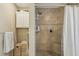 A tiled shower with built-in shelves and a shower curtain at 9322 Via Segovia, New Port Richey, FL 34655
