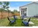 Private backyard oasis with green grass, four chairs for outdoor relaxation at 1006 E 23Rd Ave, Tampa, FL 33605