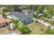 Aerial view of charming home with well-maintained backyard, white fence, shed, and stepping stones at 1006 E 23Rd Ave, Tampa, FL 33605