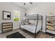 Cozy bedroom with bunk beds, a dresser, modern shelving, and natural light, creating a comfortable retreat at 1006 E 23Rd Ave, Tampa, FL 33605