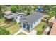 Aerial view of craftsman home with lovely landscaping, blue siding, charming porch, and walkway at 1006 E 23Rd Ave, Tampa, FL 33605