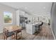 Bright kitchen with stainless steel appliances, marble countertops, white cabinetry, and eat-in island, open to living space at 1006 E 23Rd Ave, Tampa, FL 33605