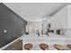 Well-lit kitchen with white cabinets, marble countertops, stainless steel appliances, and stylish pendant lighting at 1006 E 23Rd Ave, Tampa, FL 33605