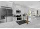 Bright kitchen showcasing white cabinets, stainless steel appliances, marble countertops and modern fixtures at 1006 E 23Rd Ave, Tampa, FL 33605