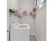 Convenient laundry area with modern washer, dryer, and ample storage shelves at 1006 E 23Rd Ave, Tampa, FL 33605