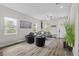 Inviting living room with many windows, a modern fan, plush seating, and a decorative plant for added ambiance at 1006 E 23Rd Ave, Tampa, FL 33605