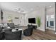 Bright living room featuring luxury seating, a ceiling fan, and a sleek television, offering a cozy space at 1006 E 23Rd Ave, Tampa, FL 33605