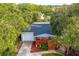 Aerial view of a cozy home with mature trees, nice landscaping, and a welcoming red porch at 1045 28Th S Ave, St Petersburg, FL 33705