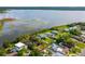 Aerial view of a lakeside neighborhood featuring a property outlined in red with mature trees and water access at 1045 28Th S Ave, St Petersburg, FL 33705